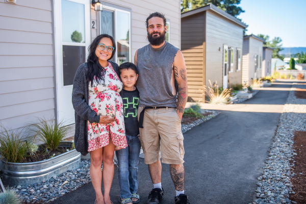 family at tiny home village funded by the affordable housing fund