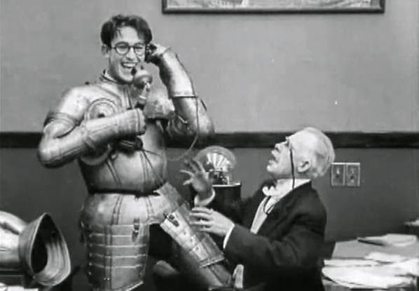 Harold Lloyd weaing knight suit and holding telephone in Ask Father