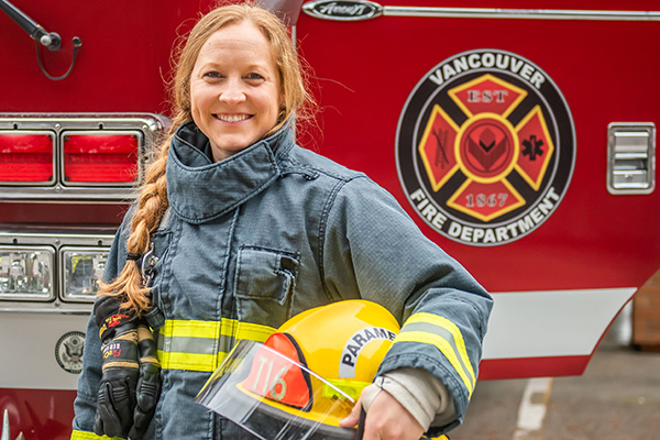 woman firefighter in front of engine