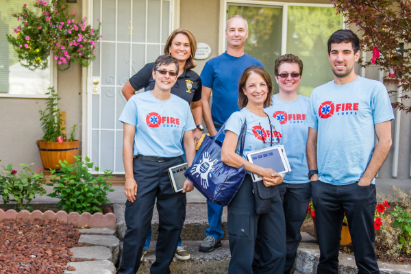 four FireCorps volunteers going door-to-door with Fire Marshal staff to share home fire prevention information