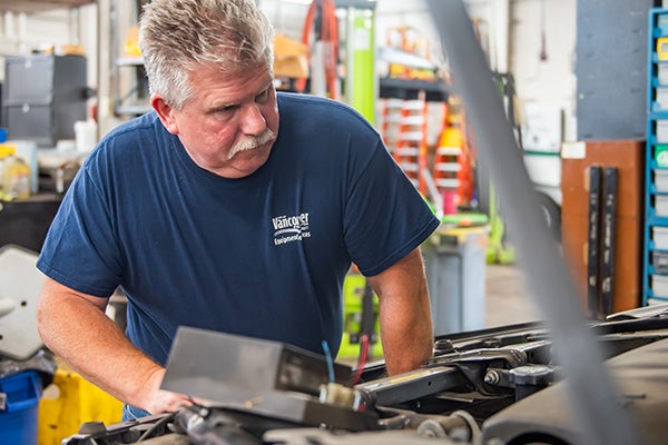 fleet services mechanic working on vehicle