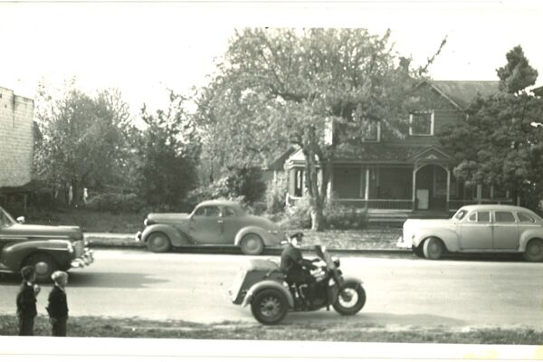 old black and white image of man on motor bike