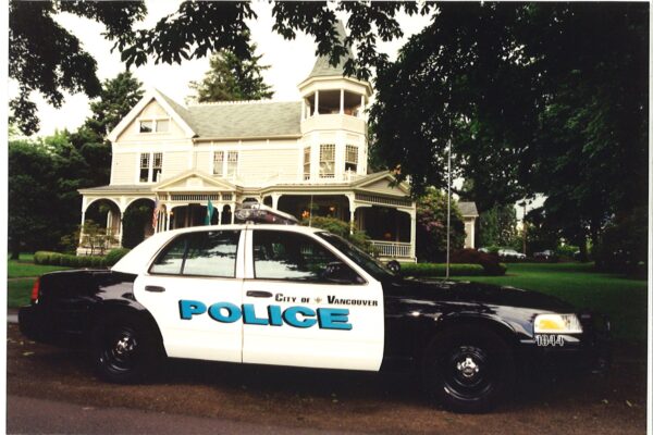 police car in front of victorian home
