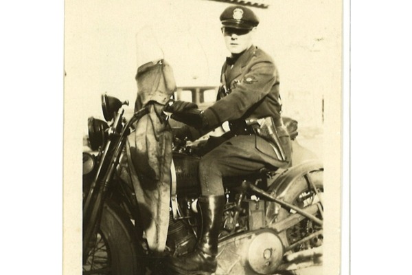sepia old image of man on motorbike