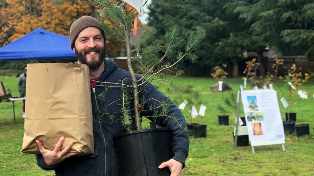 Community members picking free yard tree during annual event