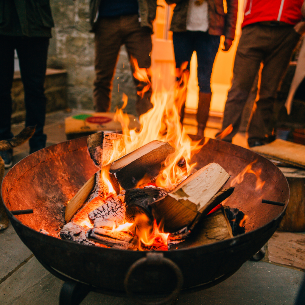 people standing around a fire pit