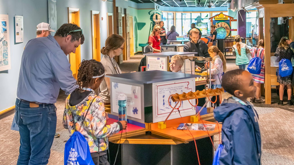 Community members exploring the Water Center's exhibit floor