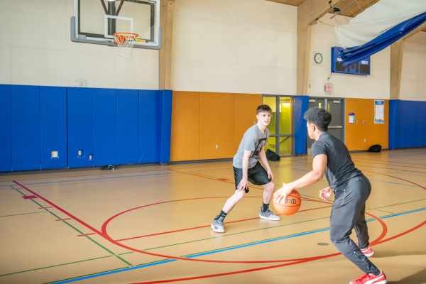 marshall gym with two teens playing basketball