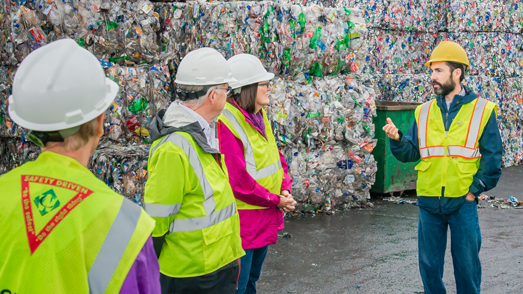 Community members taking a tour or local material recovery facility.