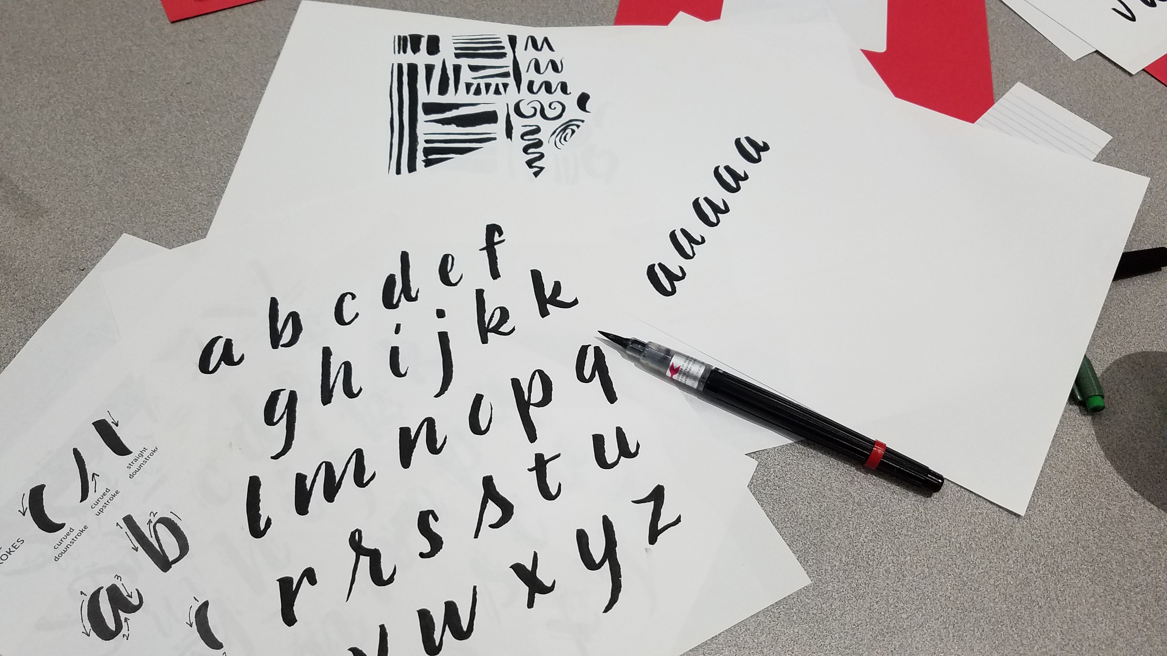 Practicing calligraphy alphabet and strokes in a hand-lettering class