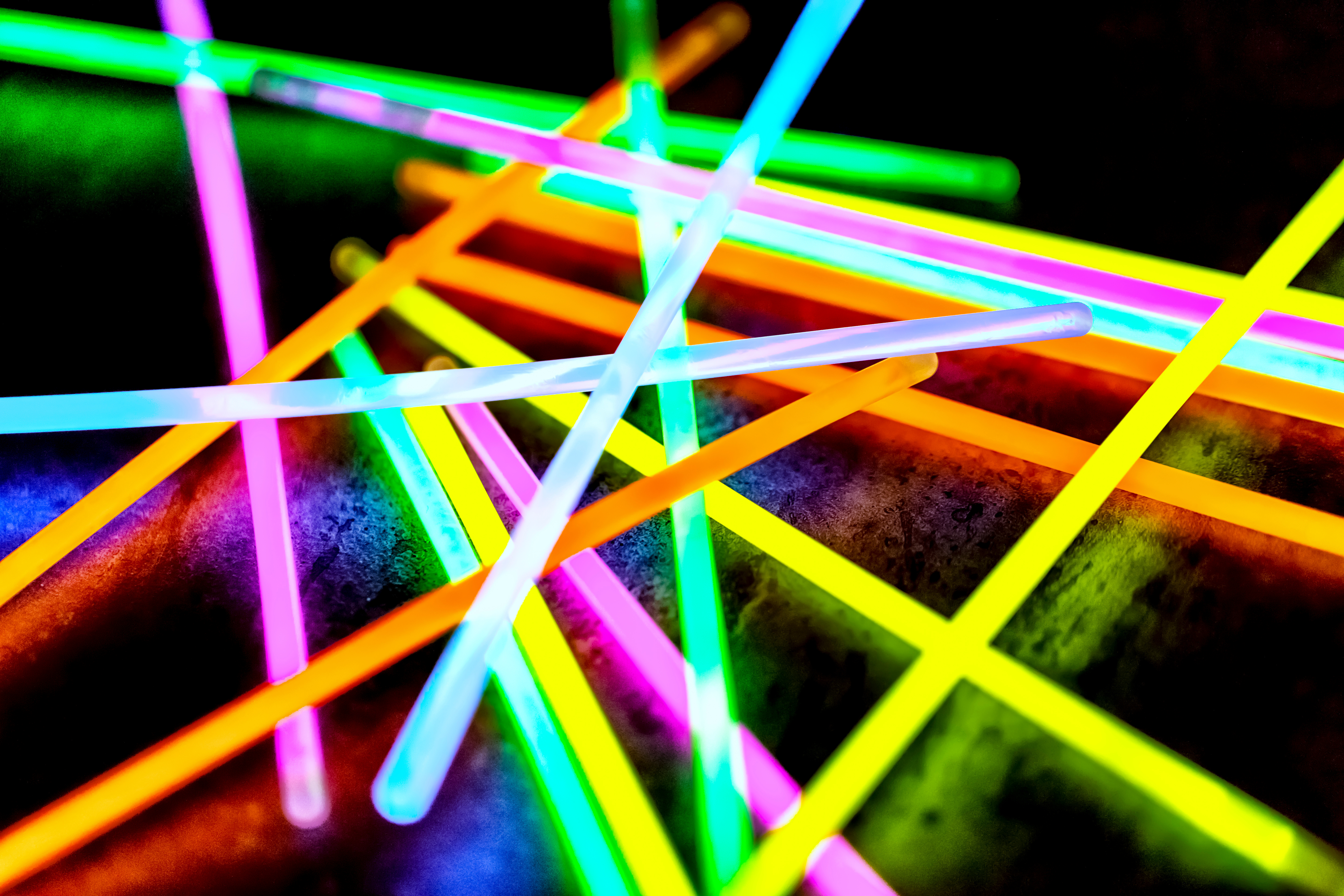 Brightly colored glow sticks on a black background