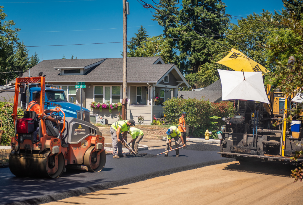 Crews resurfacing street in local neighborhood during annual summer pavement management program work