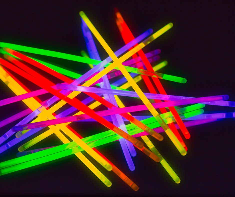 glow sticks in a pile on black background