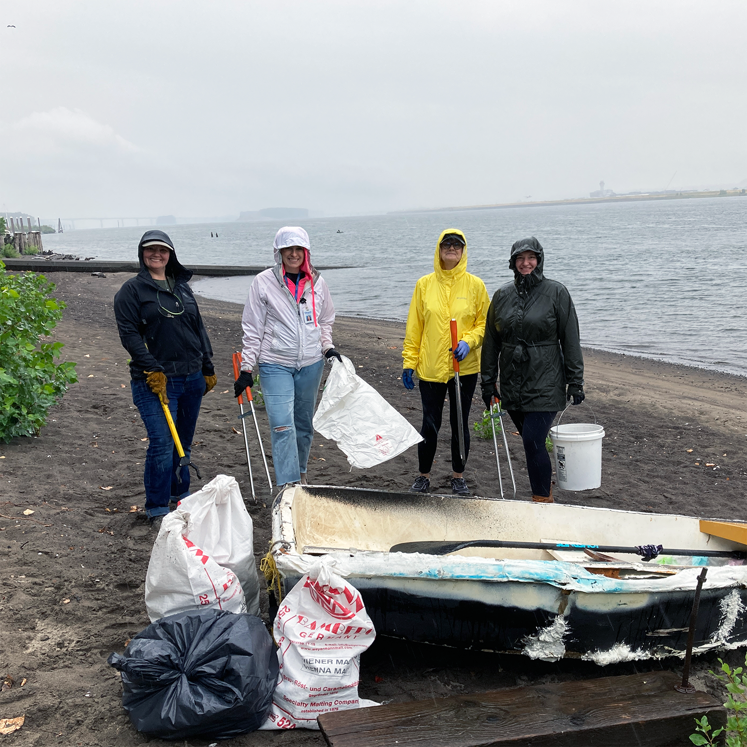 volunteers cleaning up the beach along the Columbia River