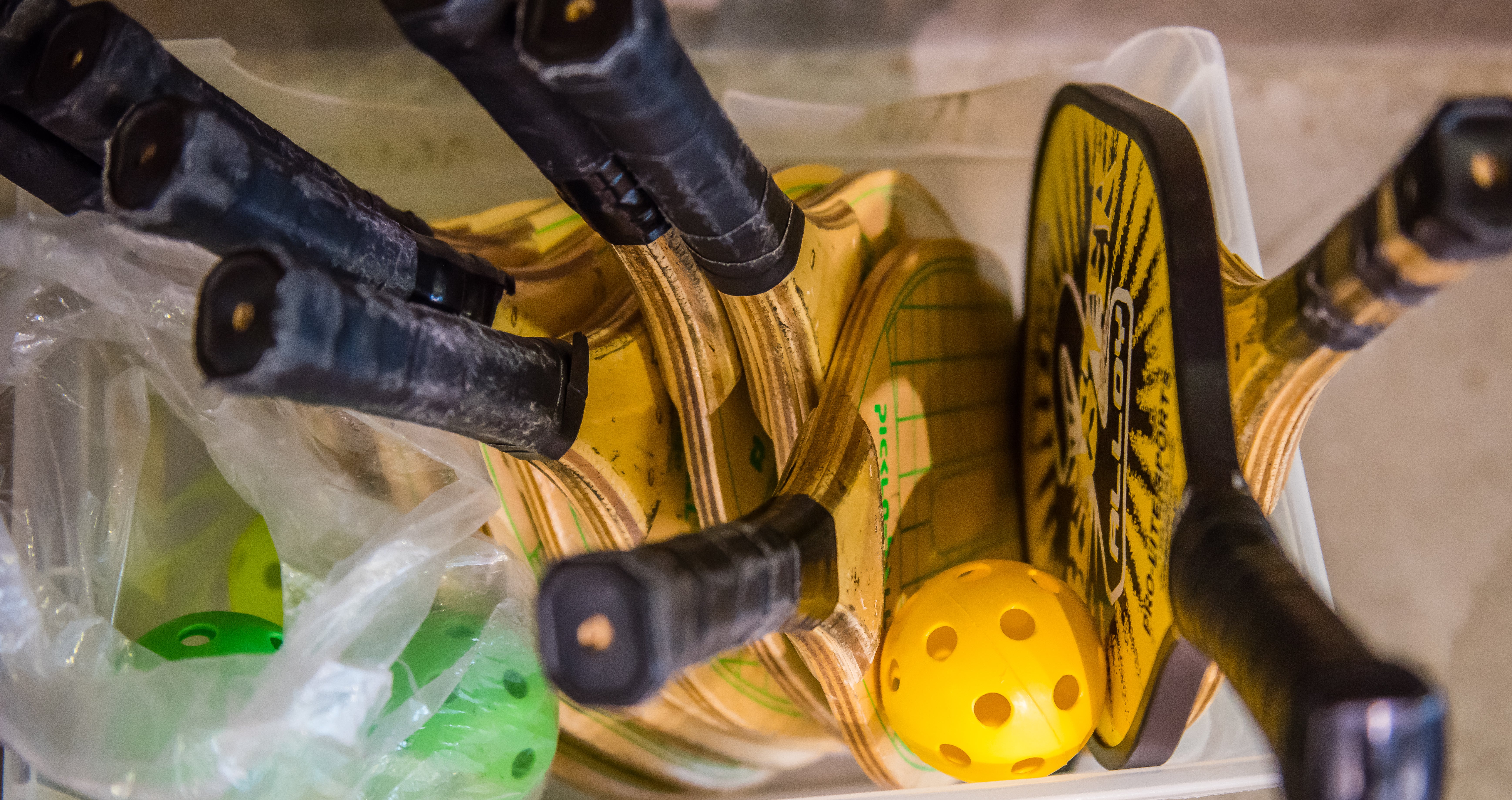 Pickleball paddles in a basket