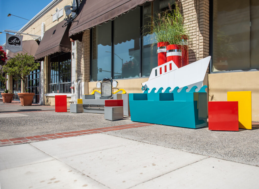 Brightly colored benches and seats designed to look like a boat, a car and abstract shapes.