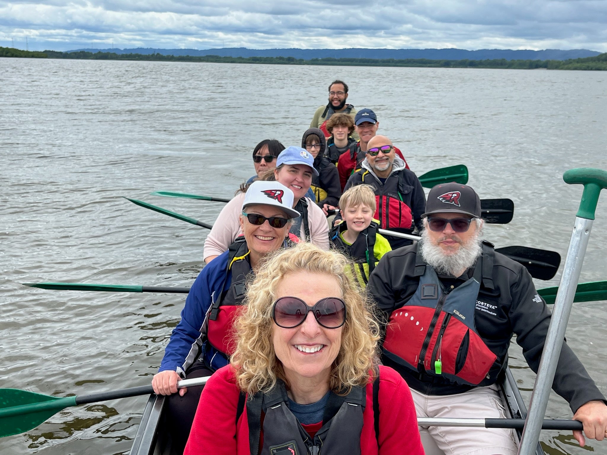 Participants smile as they paddle on Vancouver Lake