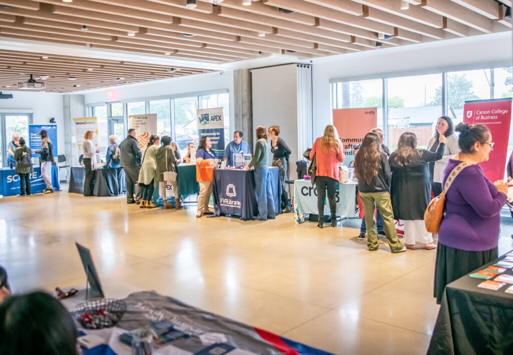 2024 Small Business Resource Fair at Fourth Plain Commons: vendor tables and guests talking to vendors