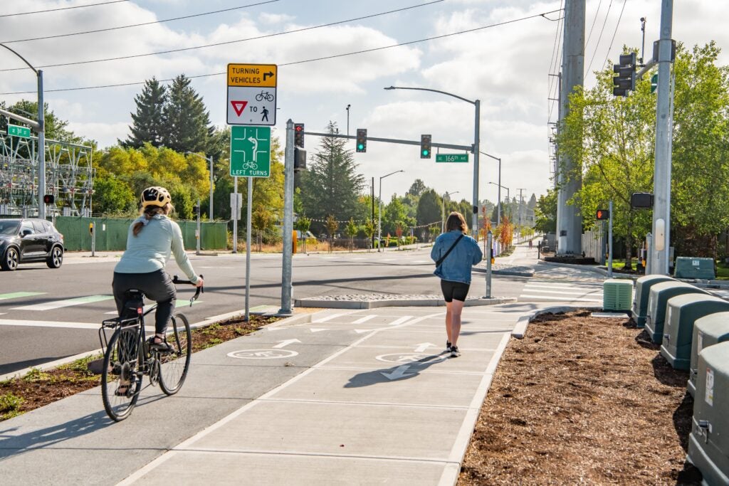 Person biking and person walking in east Vancouver