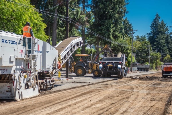 Crews paving a street