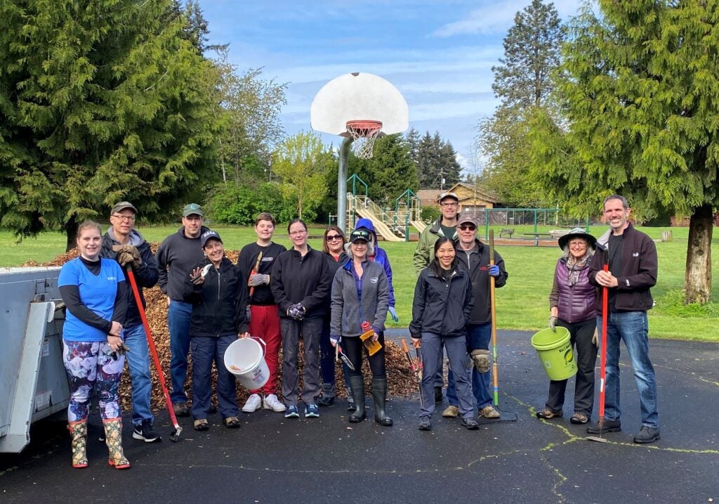group of volunteers pose on basketball court