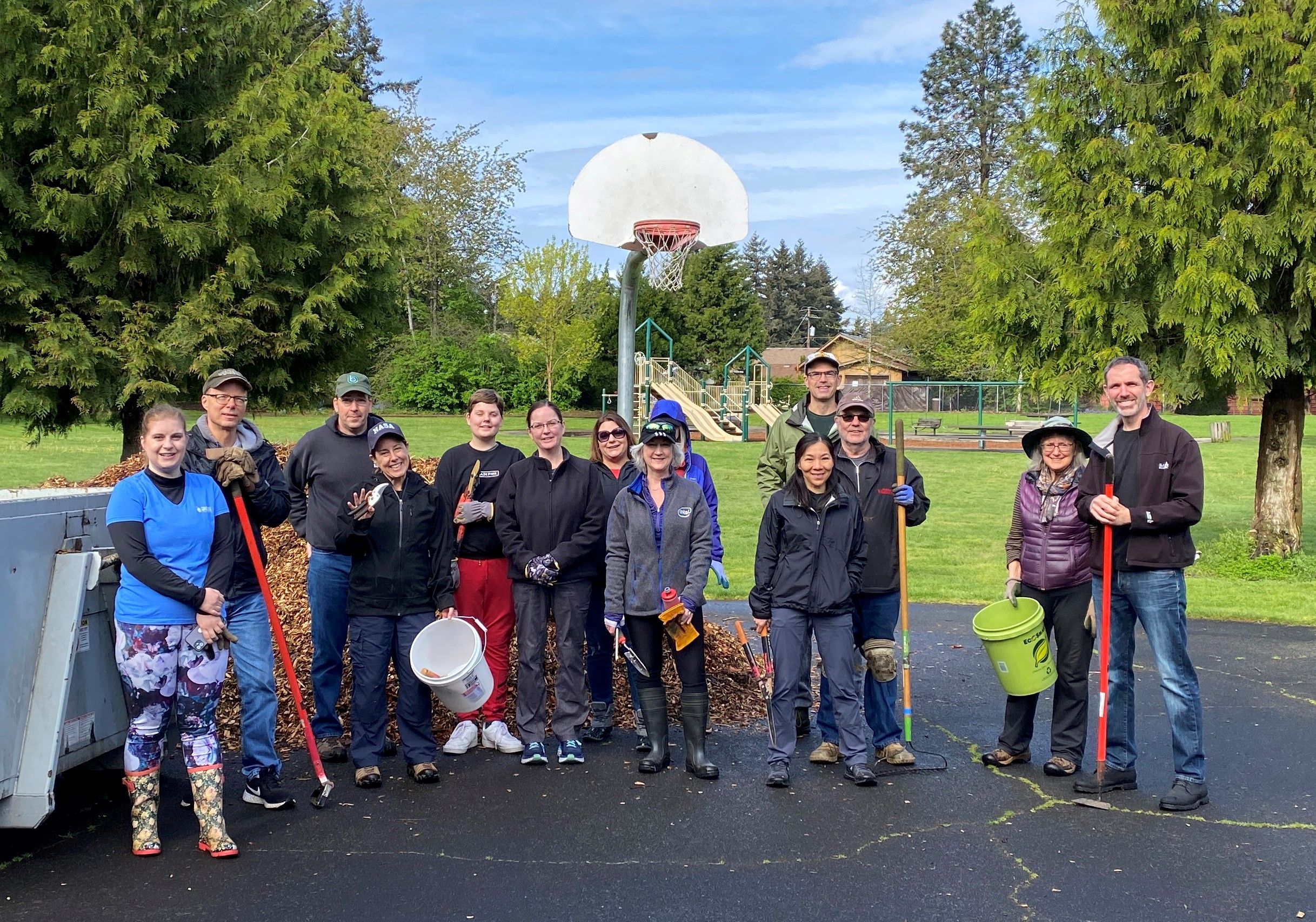 group of volunteers pose on basketball court