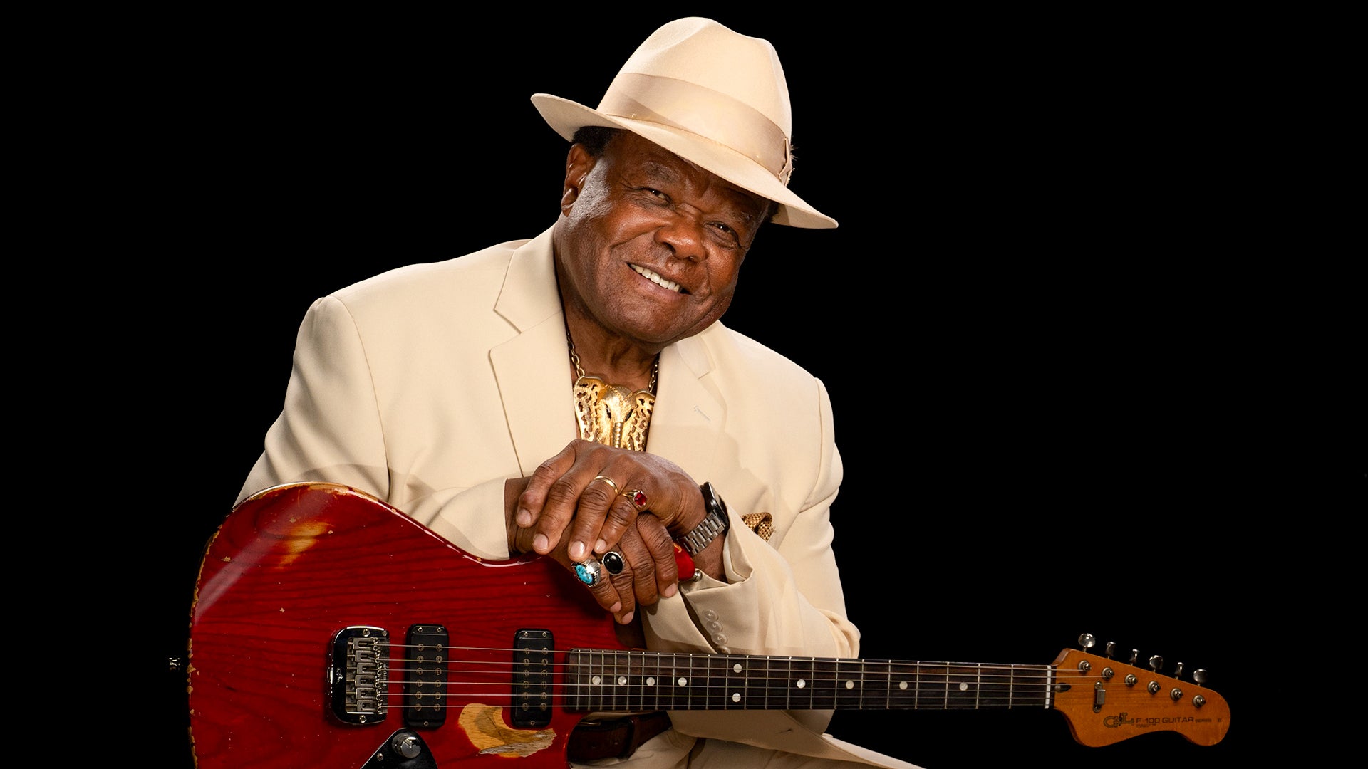 Musician, Norman Sylvester, poses with his guitar.