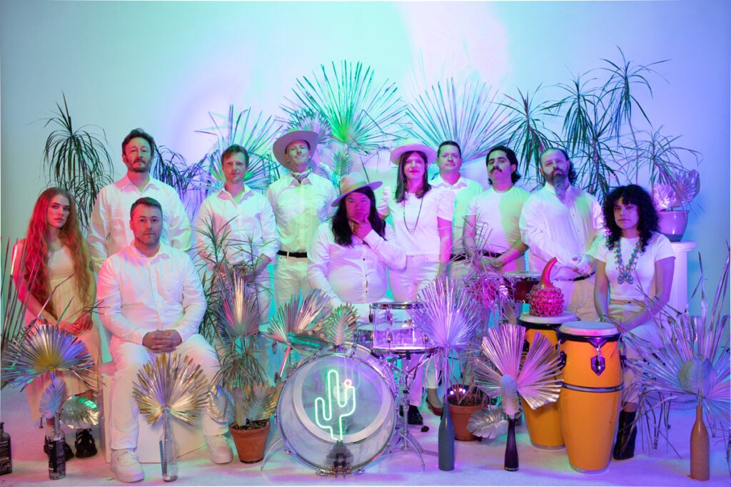 The large Orquestra Pacifico Tropical band pose together.
