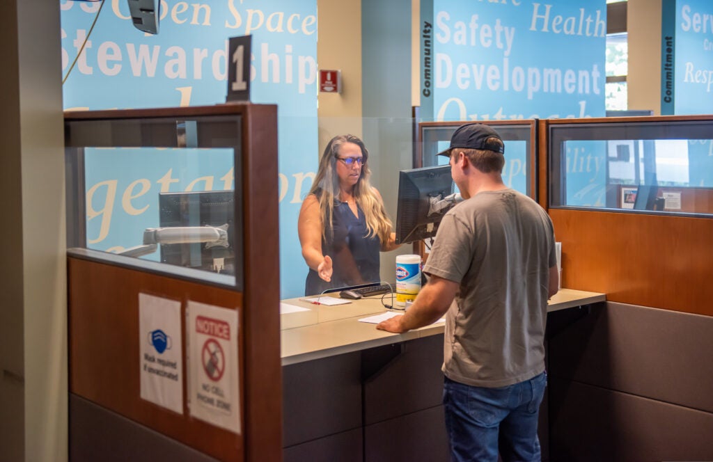 Customer interacting with staff at Permit Center counter