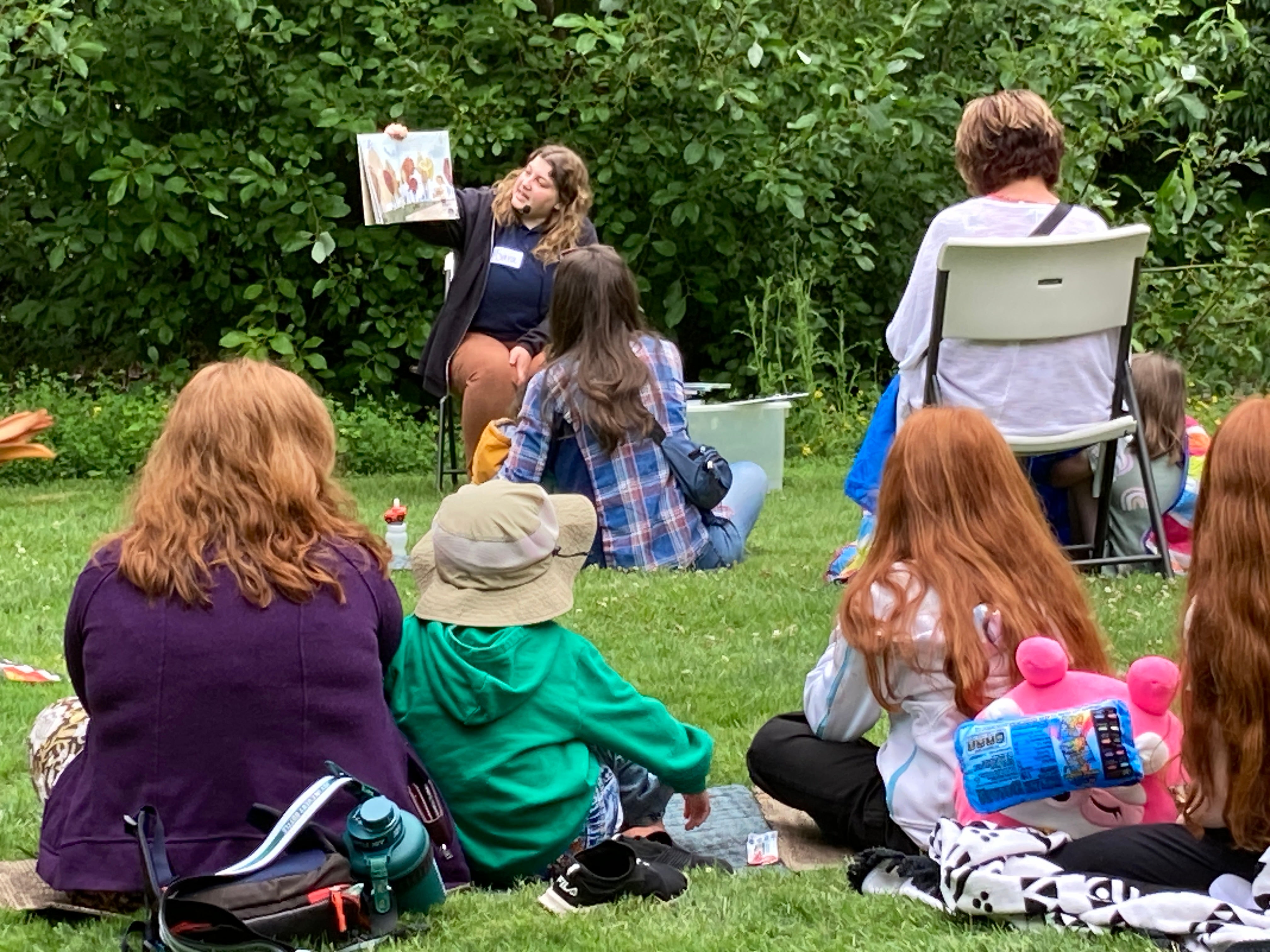 Youth listening to a story outside.