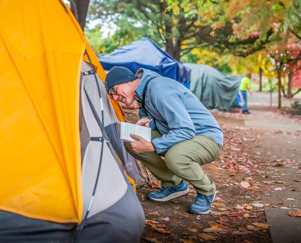 A member of the City's HART homelessness outreach team visits an encampment.