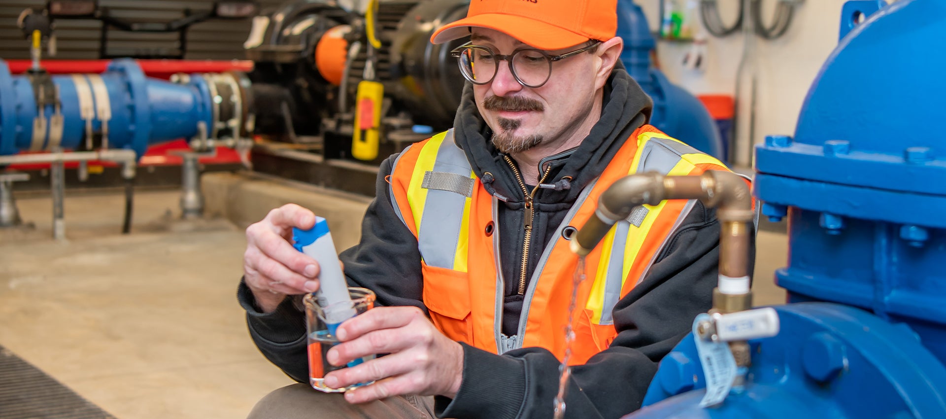 City employee wearing PPE testing water quality