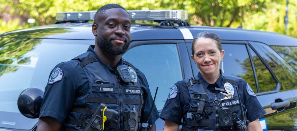 VPD officers smile in front of patrol car