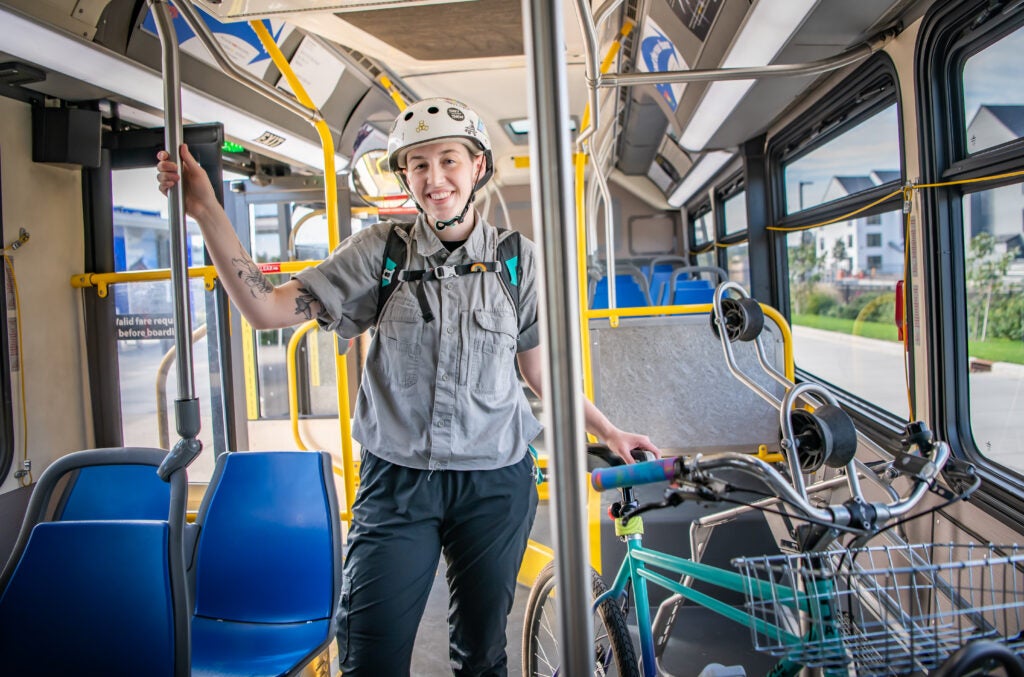  person stands on The Vine bus with their bicycle on board