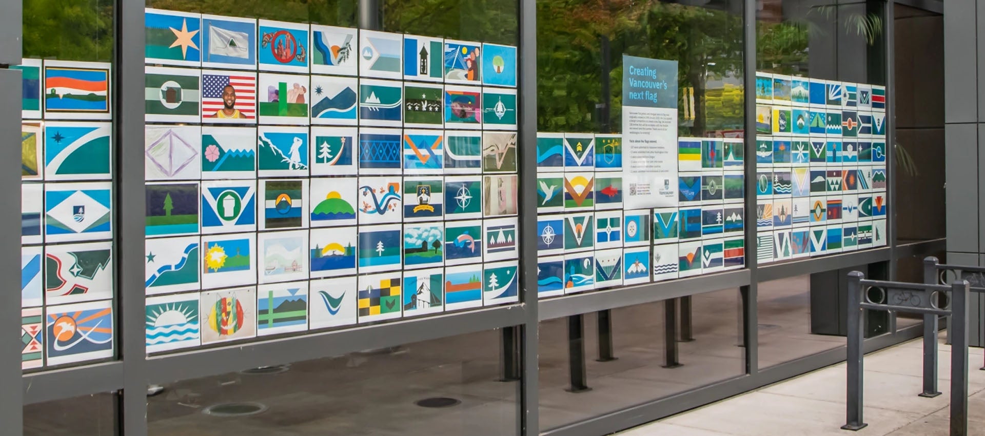 Flag design submissions posted in the windows at City Hall