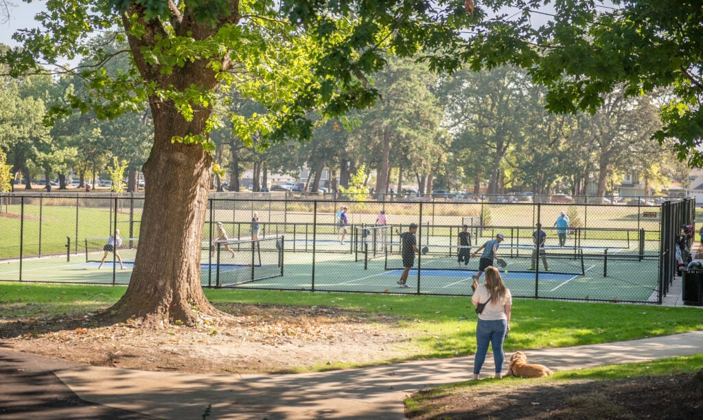 People playing pickleball at Oakbrook Park on a beautiful day.