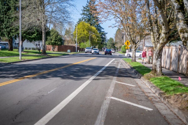 an image of 72nd Avenue near 45th street by Jaggy Road Park looking North. People are walking on the sidewalk towards the camera.