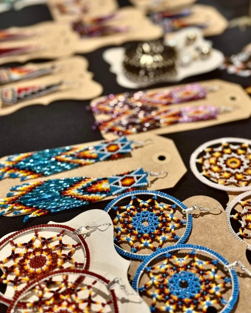 Indigenous beaded earrings displayed at a market