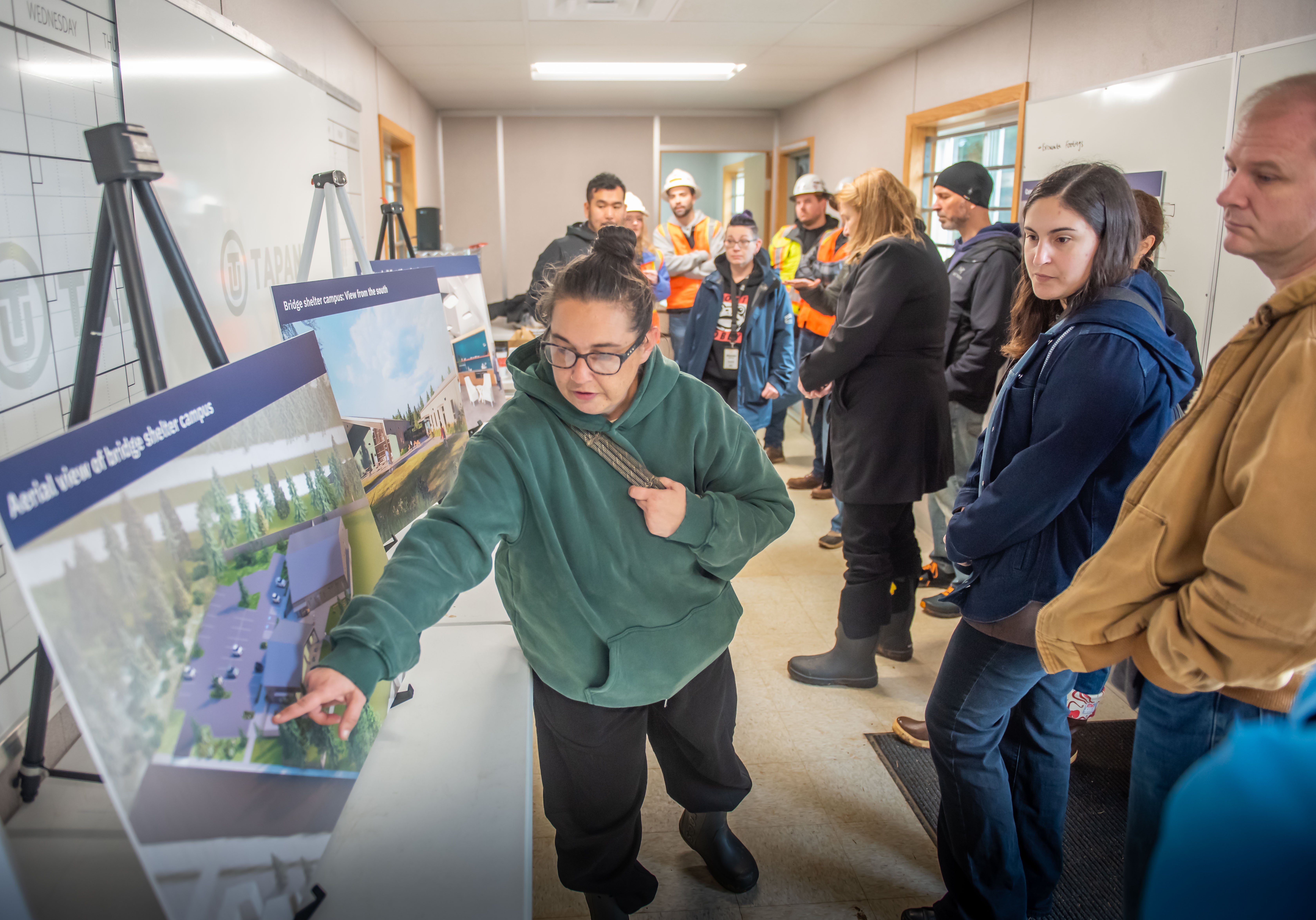 Jamie Spinelli, City Homeless Response Manager, discusses design renderings with City Councilor Kim Harless and Clark County Councilor Glen Yung.