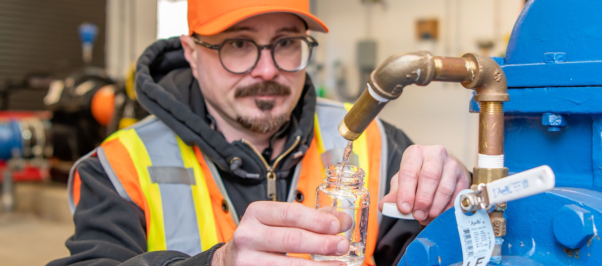 City employee wearing PPE testing water quality