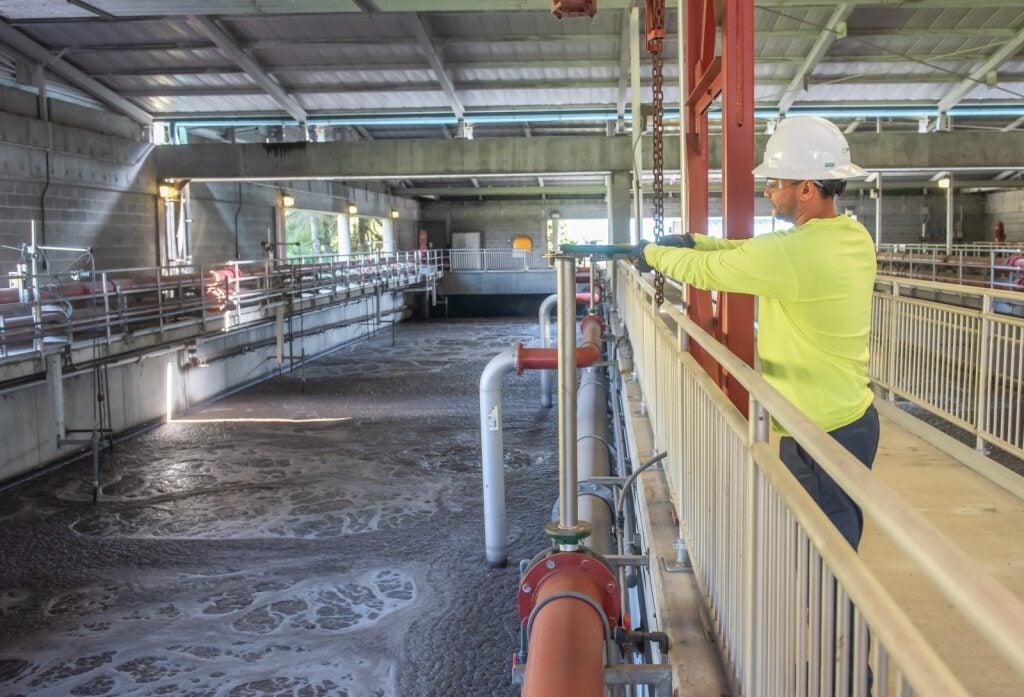 Wastewater Operator checking the aeration basin in the treatment facility.