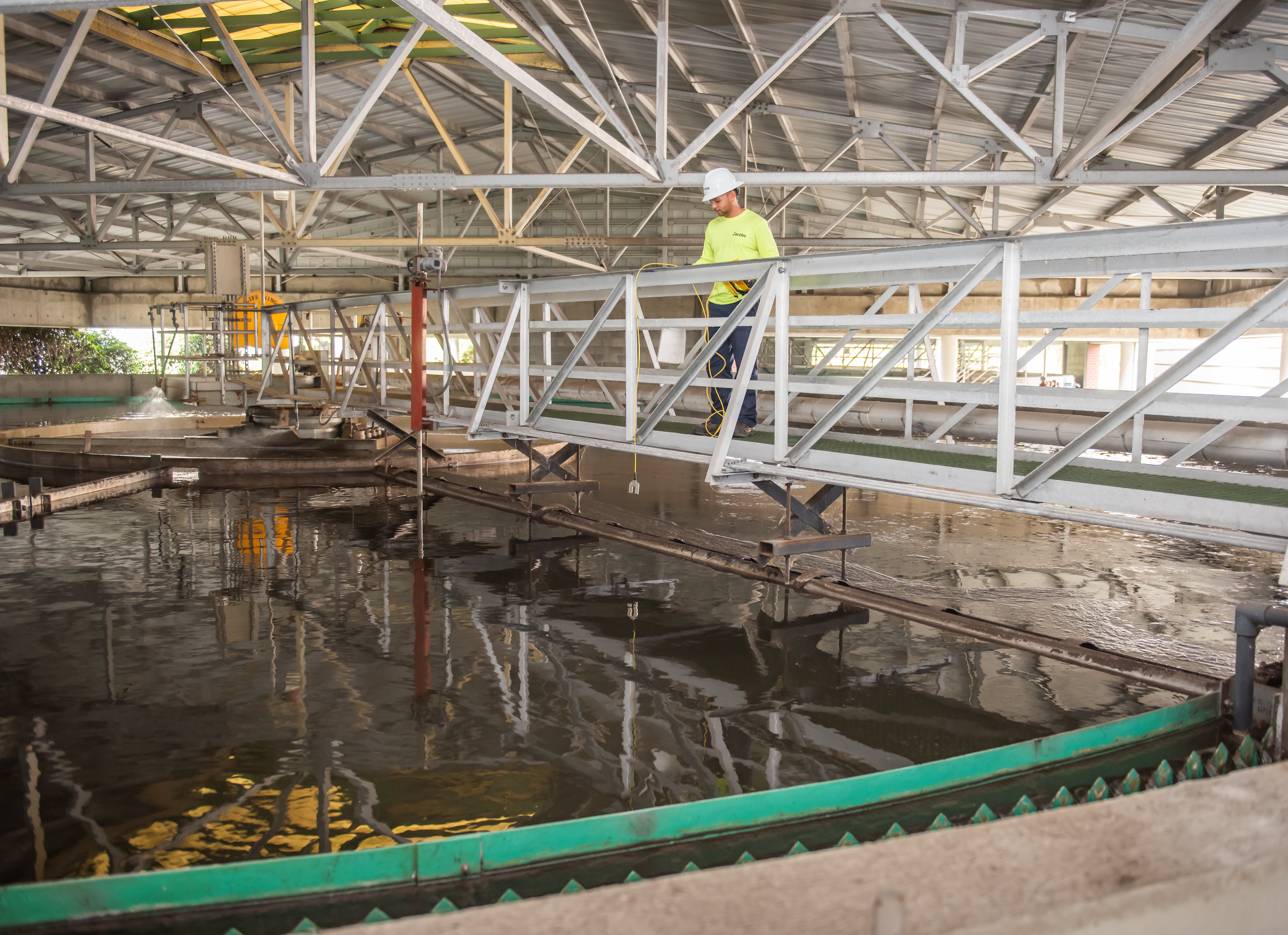 Wastewater Operator collecting water data above the Secondary Clarifier