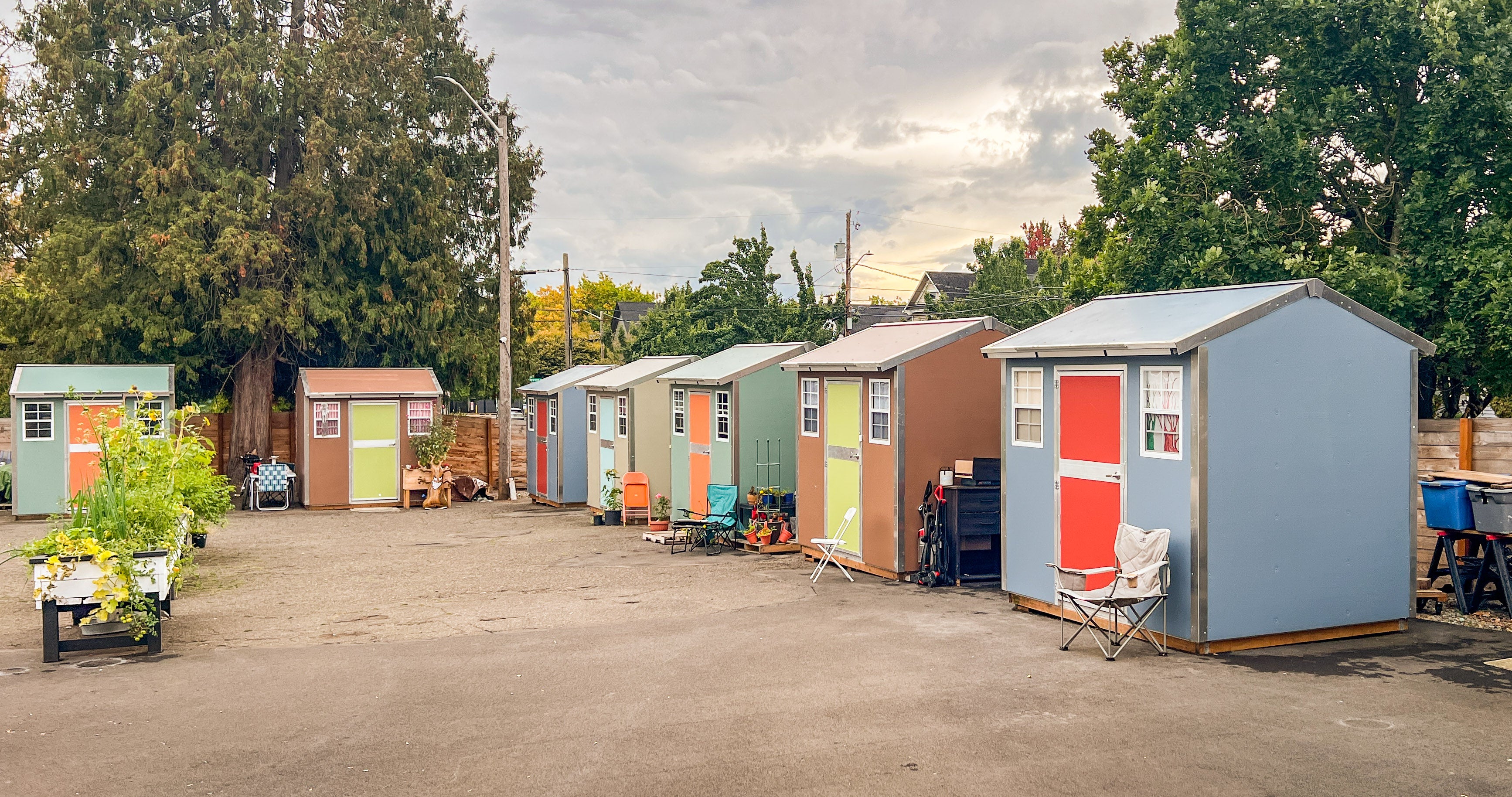 A row of colorfully painted shelter structures at the 415 West Safe Stay Community.