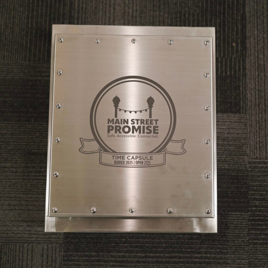 Silver time capsule box with words Main Street Promise