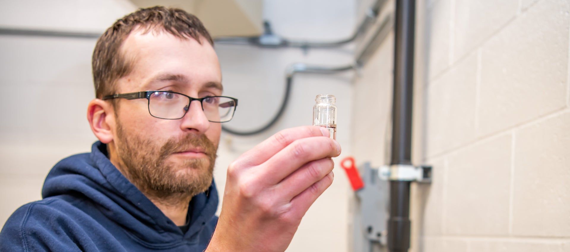 A City employee examines a water sample.
