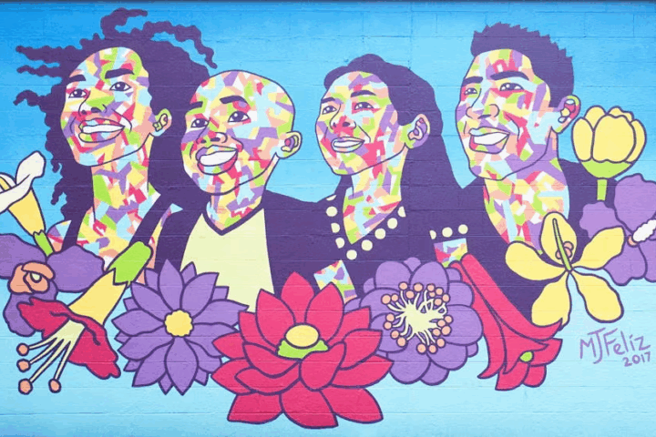 Mural of four people on a blue background with red, purple and yellow flowers on the bottom.