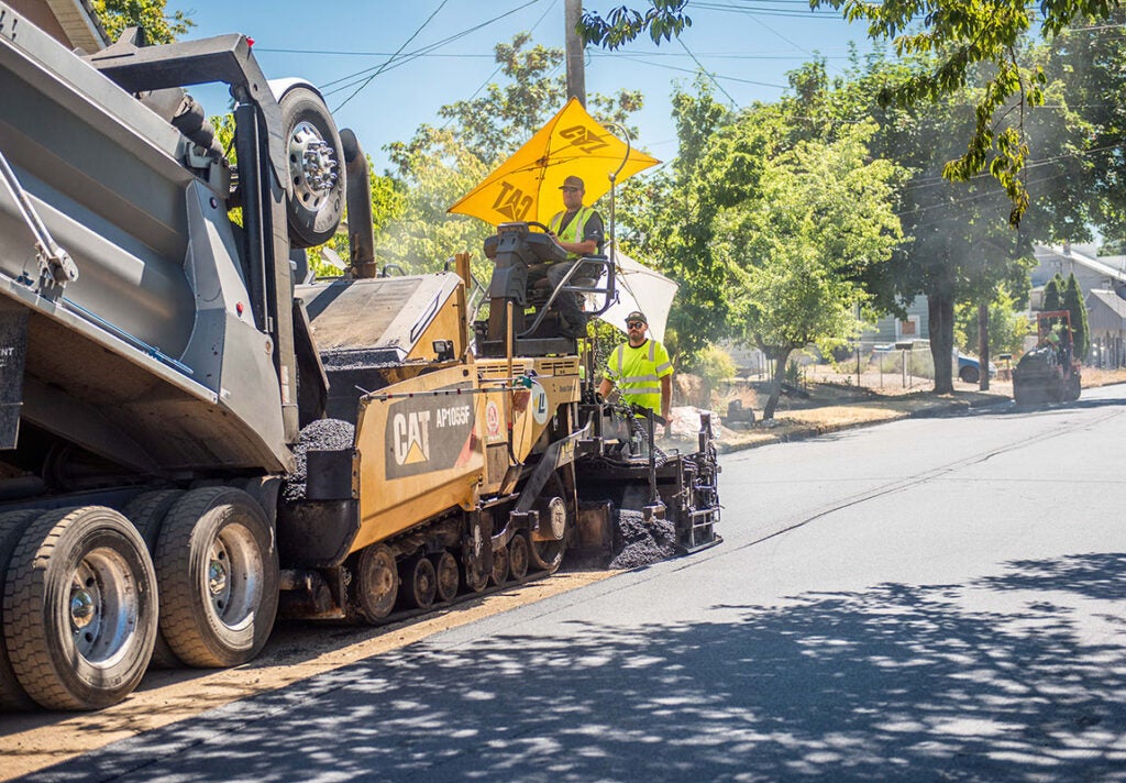 Crews work on pavement resurfacing in the Rose Village neighborhood