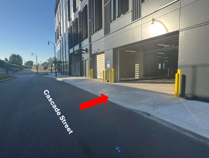 Google maps street view of the entrance of the Terminal 1 Garage, a red arrow indicating the entry point on Cascade Street.