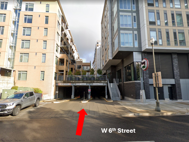 Google maps street view of the entrance of the Park n' Go Garage, a red arrow indicating the entry point on West 6th Street.
