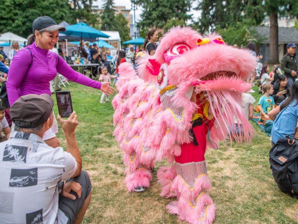 Crowd interacts with a lion dancer from the Vietnamese Community of Clark County. 